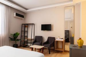 a hotel room with a bed and two chairs at Cairo Capital Hotel by SK in Cairo +9 photos