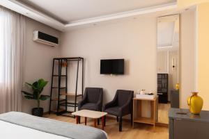 a hotel room with a bed and two chairs at Cairo Capital Hotel by SK in Cairo
