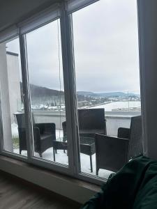a room with a large window with chairs and a table at Sunset SPA apart in Kremenetsʼ