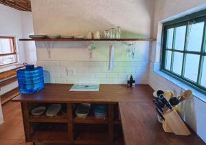 a kitchen with a wooden counter in a room at Fisherman's Cottages at Blombosch Game Farm in Yzerfontein +19 photos