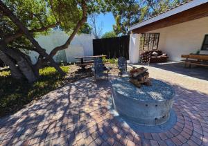 a patio with a fire hydrant and a table and chairs at Fisherman's Cottages at Blombosch Game Farm in Yzerfontein