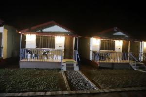 a house with a porch at night with lights at Tiger Woods in Jamania