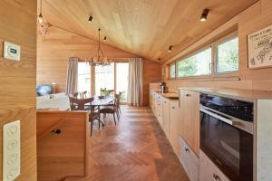 a kitchen and dining room with a dining table at IDAHO - Hoog in Süderstapel +22 photos