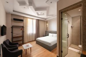 a hotel room with a bed and a chair at Cairo Capital Hotel by SK in Cairo