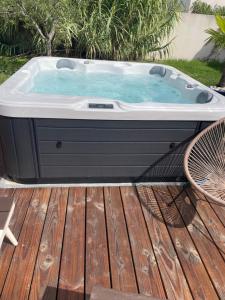 a jacuzzi tub sitting on a deck at L annexe chambre indépendante avec entrée privée in Fouras