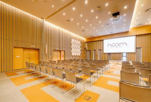 a room with chairs and a screen in it at Noom Hotel Abidjan Plateau in Abidjan +144 photos