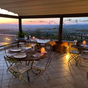 a patio with tables and chairs with a view at La Cianella - Adult Only in Scarlino