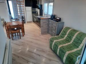 a living room with a couch and a kitchen at L'Abri Côtier 2 in Les Sables-d'Olonne