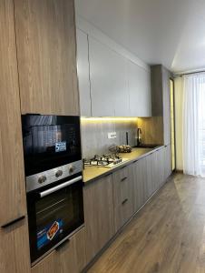 a kitchen with a stove and a stove top oven at Sunset SPA apart in Kremenetsʼ