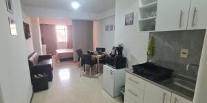 a kitchen with a table and a dining room at Monoambiente céntrico 01 in Asunción
