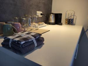 a counter top with towels and other items on it at Dalerheugte Drenthe B&B Wellness 6 met romantisch bad en ontbijt à la carte op de kamer in Dalerveen