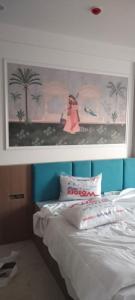 a bedroom with a bed with a painting on the wall at The bhandhavghad regency in Udaipur