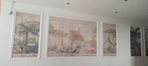three framed pictures on a wall in a room at The bhandhavghad regency in Udaipur
