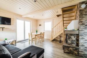 a living room with a couch and a fireplace at Orawska Sielanka in Roztoki