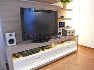 a flat screen tv sitting on top of a entertainment center at Ostseebrise - Bade- & Saunawelt täglich inklusive in Thiessow