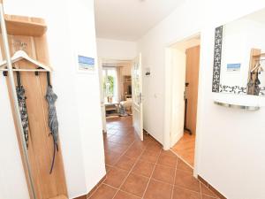 a hallway with a door and a tile floor at Ostseebrise - Bade- & Saunawelt täglich inklusive in Thiessow +12 photos