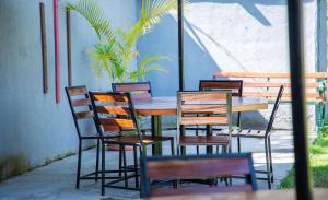 a wooden table and chairs sitting around a table at Lion Hill Place in Nakuru