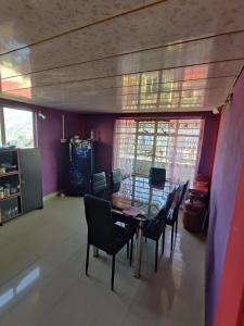 a dining room with a table and chairs at Tenzing Homestay in Kalimpong +7 photos