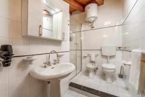 a white bathroom with a sink and a toilet at Busacca Suite in Scicli +15 photos