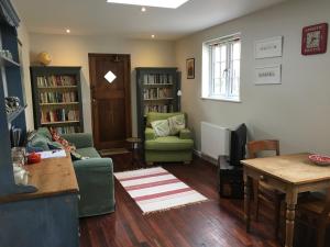 a living room with a couch and a table at North Street annexe in Ilminster
