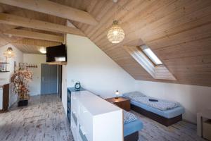 a room with two beds and a table in it at Chalupa Máša in Liptovský Trnovec