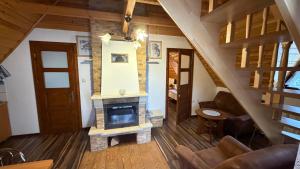 a living room with a fireplace in a house at Noclegi u Gubały in Szaflary