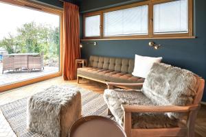 a living room with a couch and two chairs at IDAHO - Deep in Süderstapel