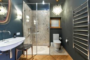 a bathroom with a shower and a sink and a toilet at IDAHO - Deep in Süderstapel