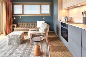a kitchen with a couch and a chair in a room at IDAHO - Deep in Süderstapel