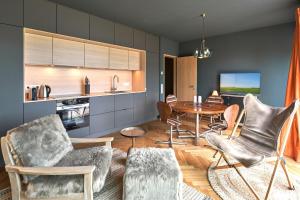 a kitchen and dining room with a table and chairs at IDAHO - Deep in Süderstapel +14 photos