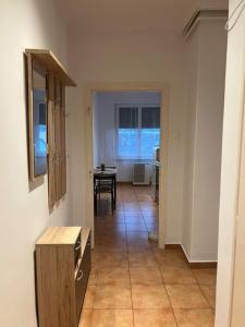 a room with a hallway with a table and a table at Greatforest apartman 2 in Debrecen +3 photos