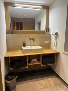 a bathroom with a sink and a mirror at Appartement Steinbergrose in Leogang +19 photos