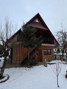 a log cabin with snow on the ground at Noclegi u Gubały in Szaflary