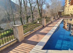a bridge over a river with a pool of water at El ático de la Gorga in Boltaña