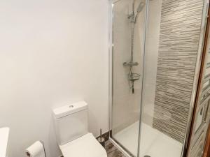 a bathroom with a toilet and a glass shower at Cygnet Cottage in Berwick-Upon-Tweed +23 photos