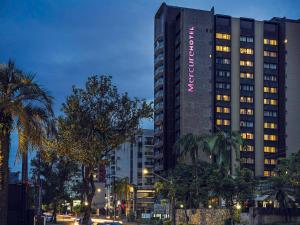 a tall building with a sign on the side of it at Prinz Loft in Joinville
