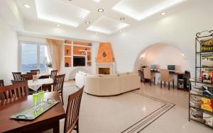 a living room with a couch and a dining room at Anastasis Apartments and Spa in Imerovigli