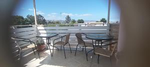 a balcony with two tables and chairs on a balcony at Anyrcoy in Viña del Mar