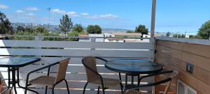 a patio with two tables and chairs on a balcony at Anyrcoy in Viña del Mar +10 photos