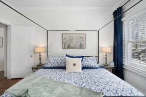 a bedroom with a bed with blue and white pillows at Cruise the waterways from your backyard in Bradenton