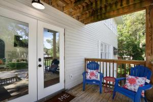 two blue chairs on a porch with a door at Cruise the waterways from your backyard in Bradenton