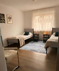 a room with two beds and a window at Ferienwohnung TALISA in Günzburg