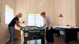 two women standing in a room with a ping pong table at Villavilla 171 - Ebeltoft, Østjylland in Ebeltoft