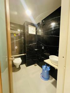 a bathroom with a toilet and a sink at Hotel Valley in Akteshwar