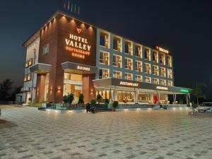 a hotel building with a parking lot in front of it at Hotel Valley in Akteshwar
