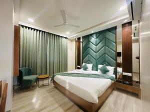 a bedroom with a bed and a green wall at Hotel Valley in Akteshwar