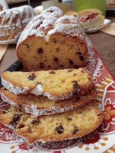 three muffins stacked on a plate with powdered sugar at B&B Casa Caporali in Fabriano +20 photos
