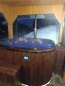 a jacuzzi tub in front of a window with snow at Czesławka in Zawoja