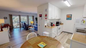 a kitchen and living room with a table in a kitchen at Atlantic Breeze #7 in Jekyll Island