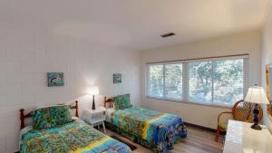 a bedroom with two beds and a window at Atlantic Breeze #7 in Jekyll Island